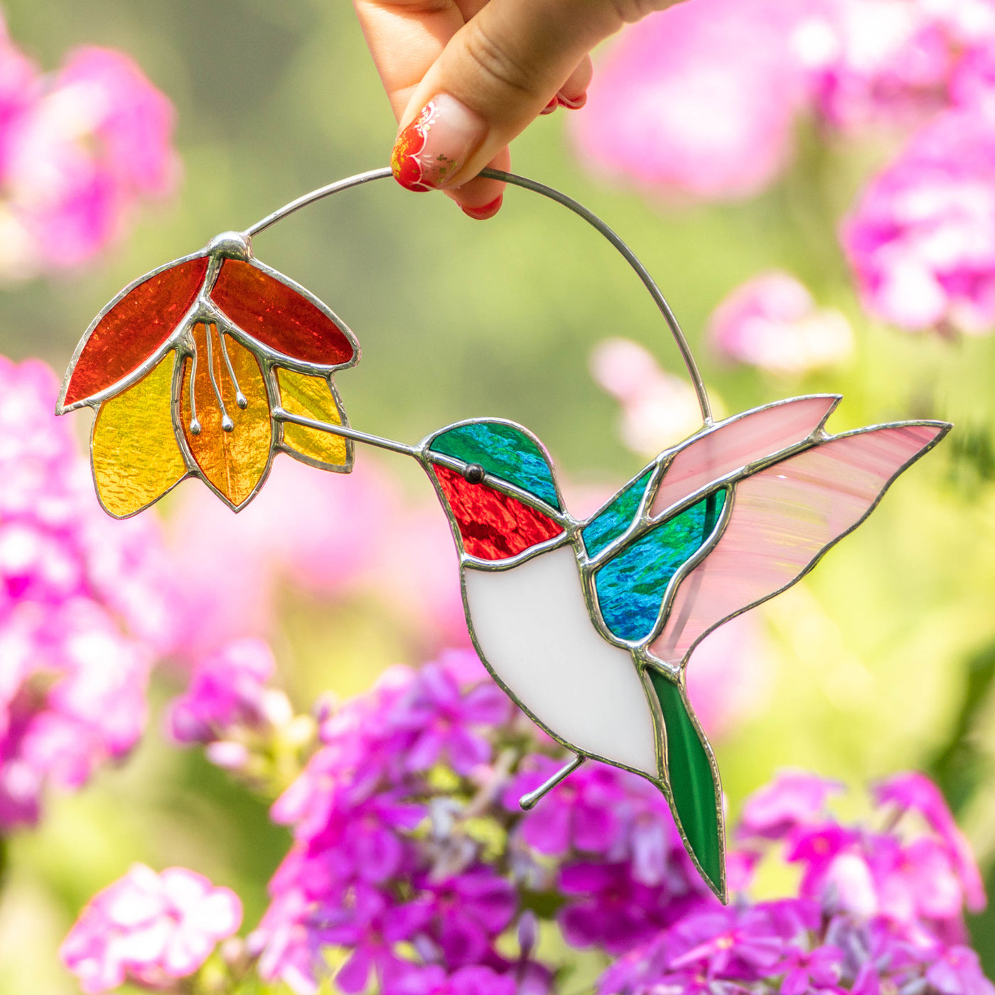 Stained glass hummingbird with white belly with the flower suncatcher