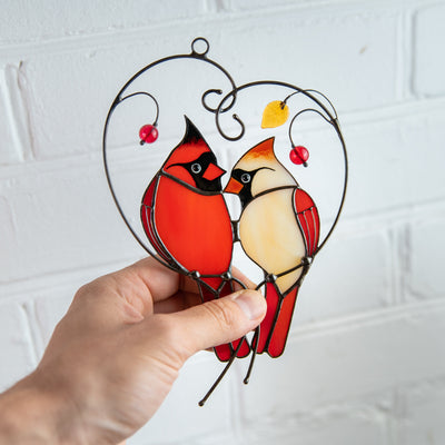 Suncatcher of a stained glass pair of cardinals on the branch