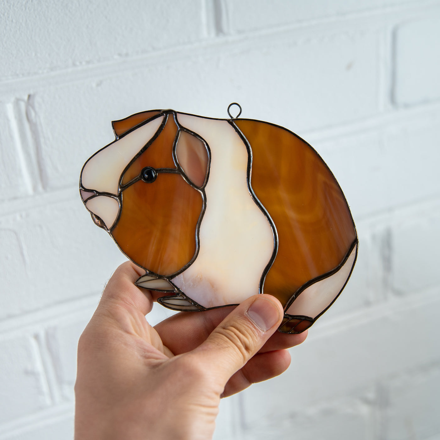 Suncatcher of a stained glass guinea pig for window