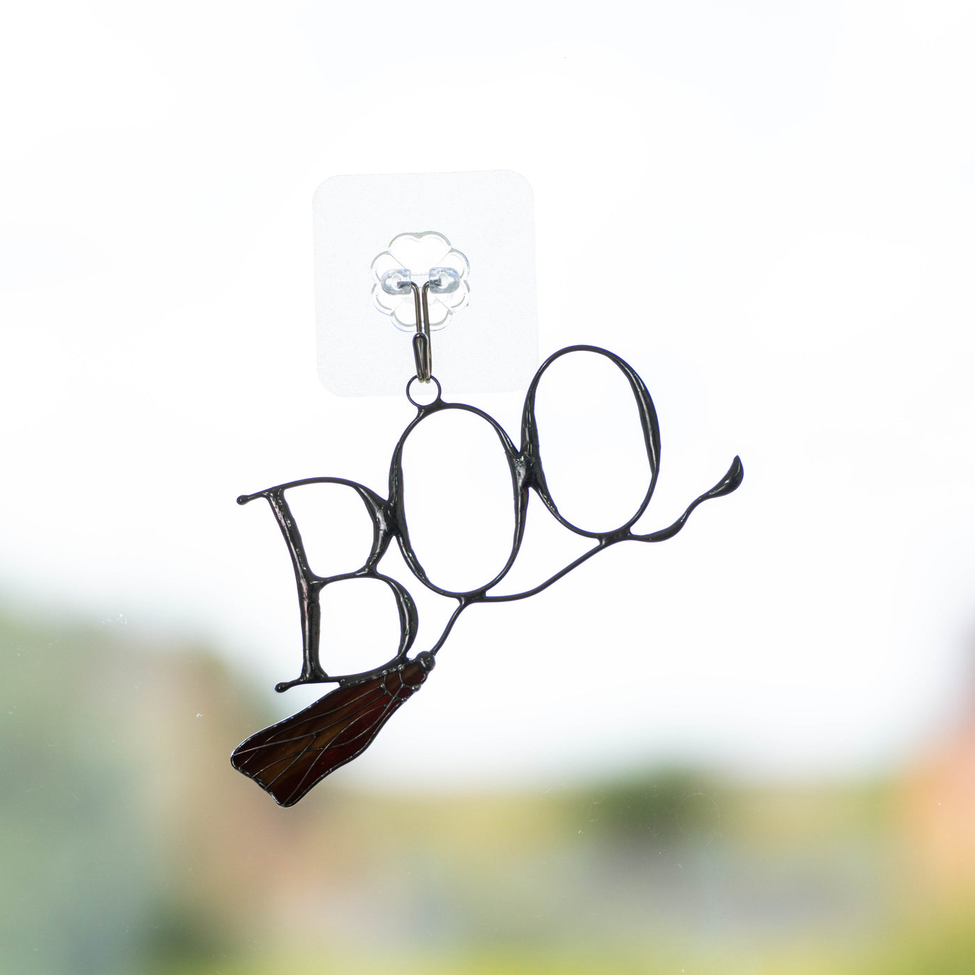Stained glass lettering boo on witch's broom suncatcher