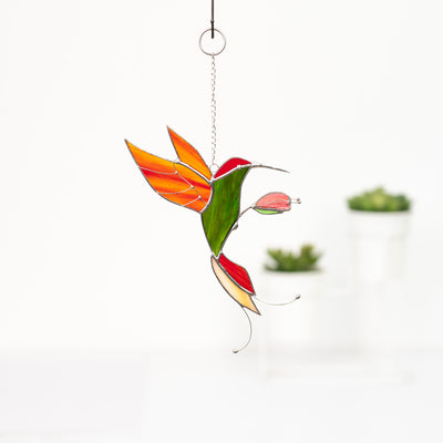 Stained glass handmade suncatcher of a bright phoenix hummingbird 