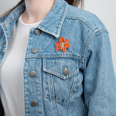 Stained glass lily brooch on a jeans jacket