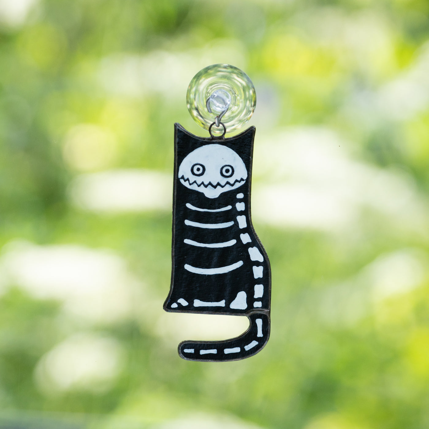Stained glass Halloween suncatcher of a cat skeleton