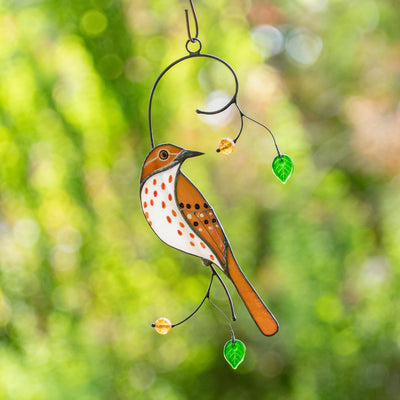 Stained glass brown thrasher sitting on the branch with leaves and berries suncatcher for home decor
