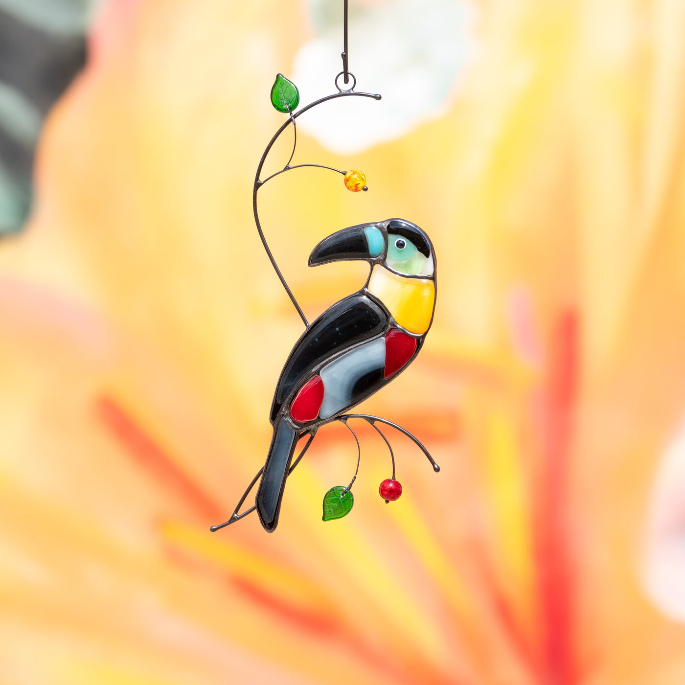 Zoomed  toucan with bluish head and yellow neck suncatcher of stained glass