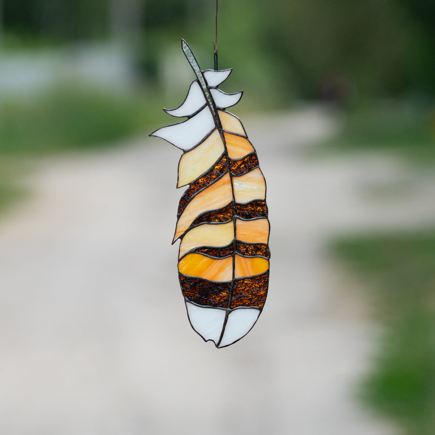 Suncatcher of a stained glass hawk feather for home decor