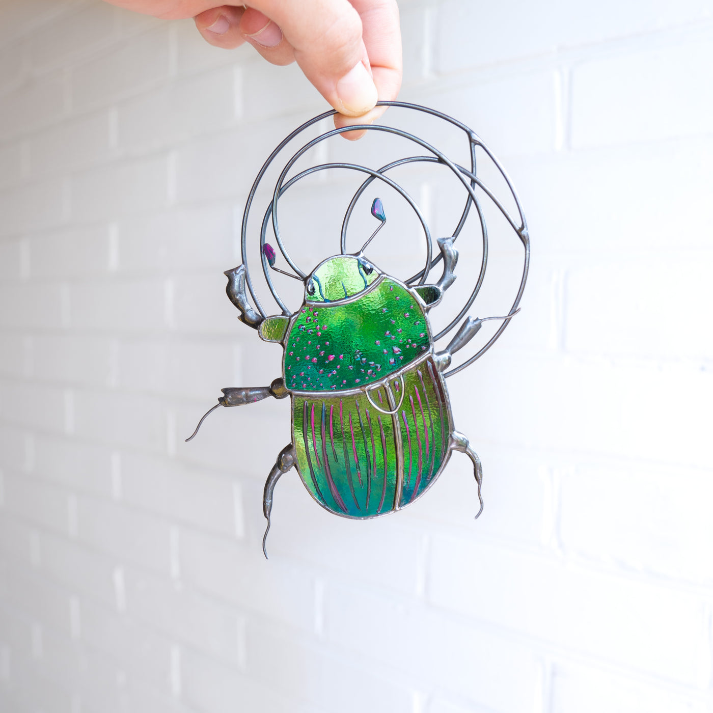 Stained glass iridescent green scarab with the net above window hanging