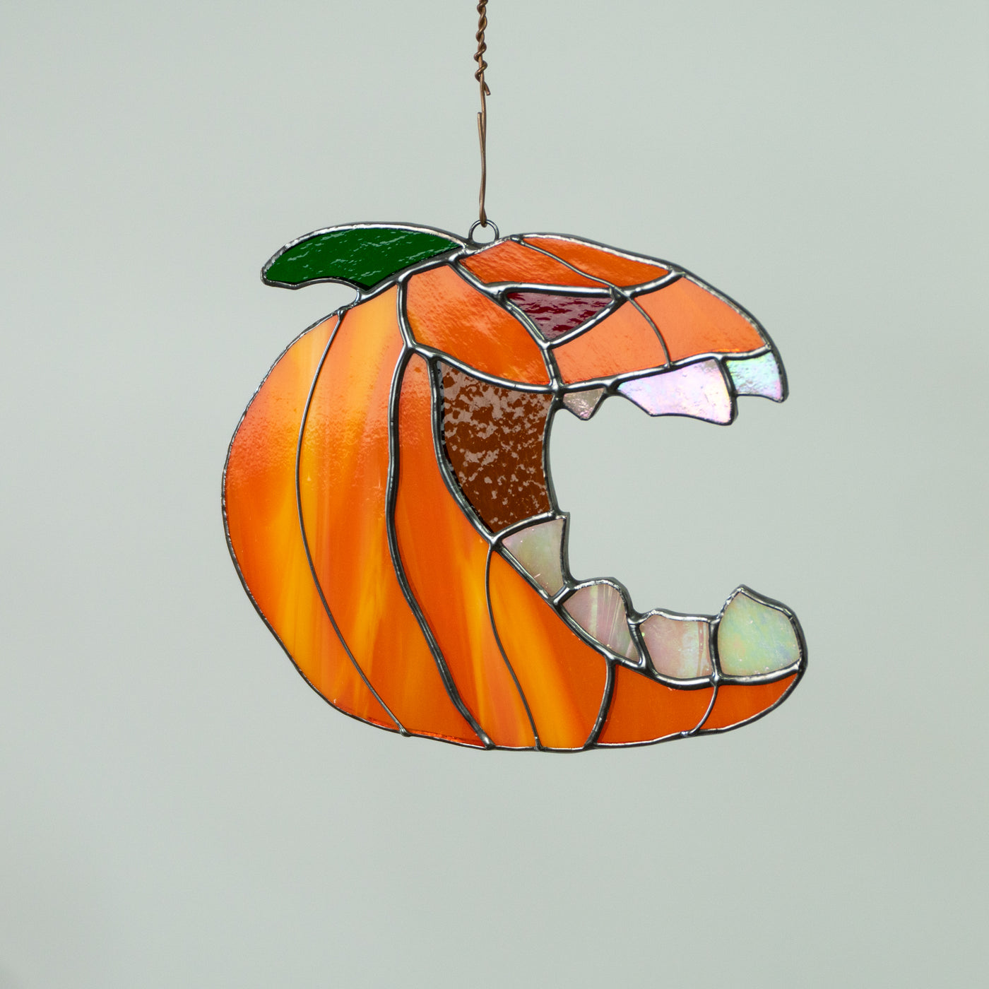 Stained glass pumpkin with the fangs window hanging for Halloween decor