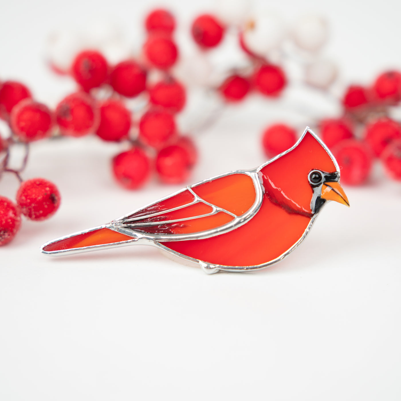 Zoomed stained glass red cardinal looking right brooch