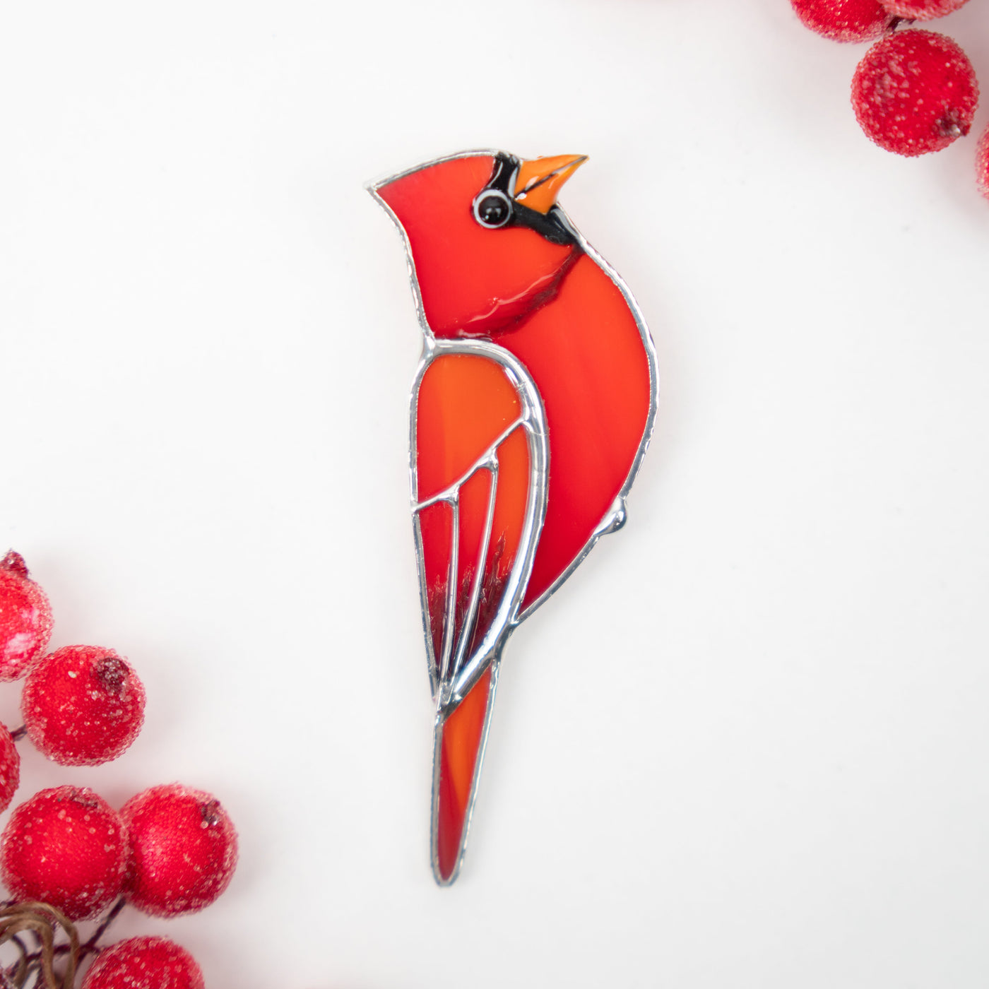 Red cardinal looking right pin of stained glass