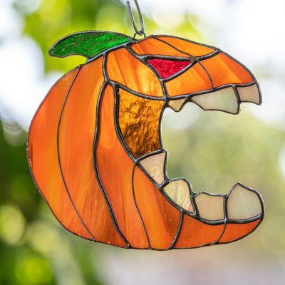 Zoomed stained glass pumpkin with the fangs window hanging 