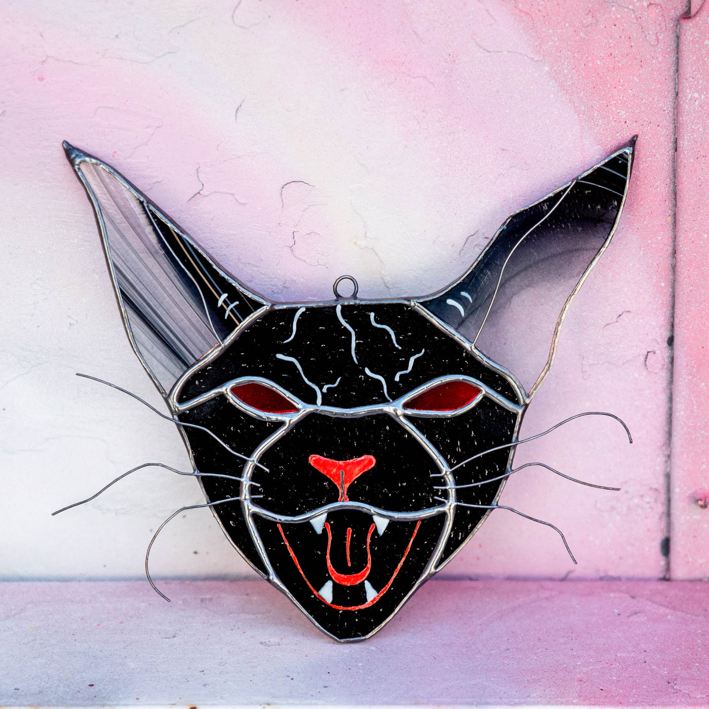 Stained glass vampire cat with red eyes window hanging