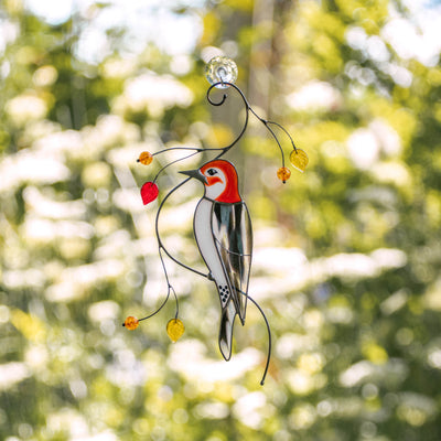 Stained glass woodpecker on the branch suncatcher
