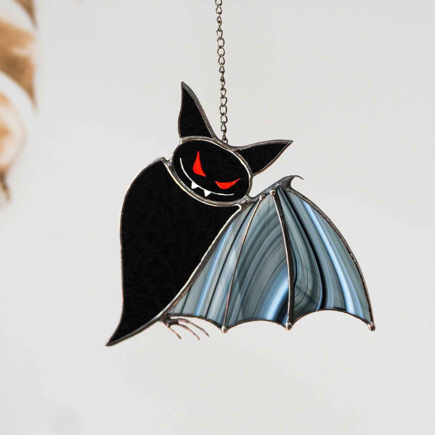 Stained glass black bat with red eyes and baroque wings suncatcher