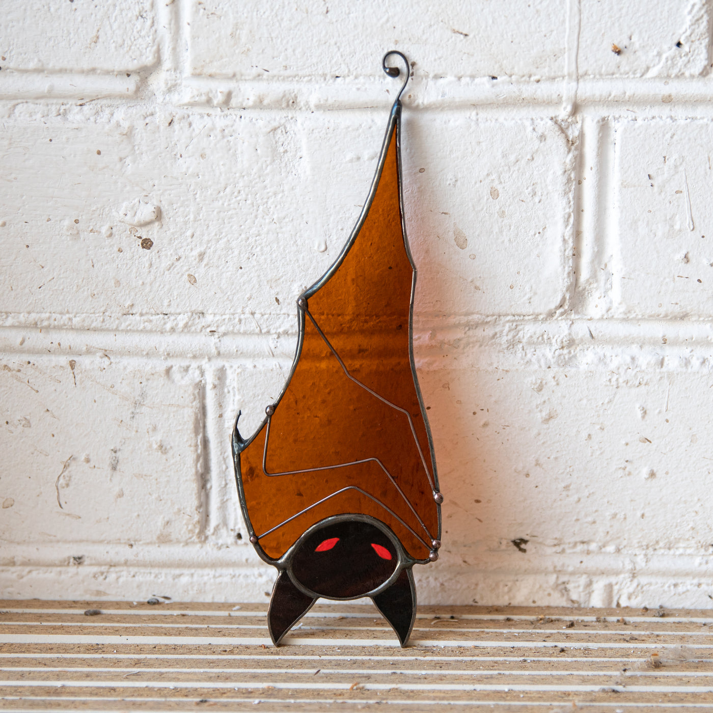 Hanging down stained glass brown bat with red eyes suncatcher