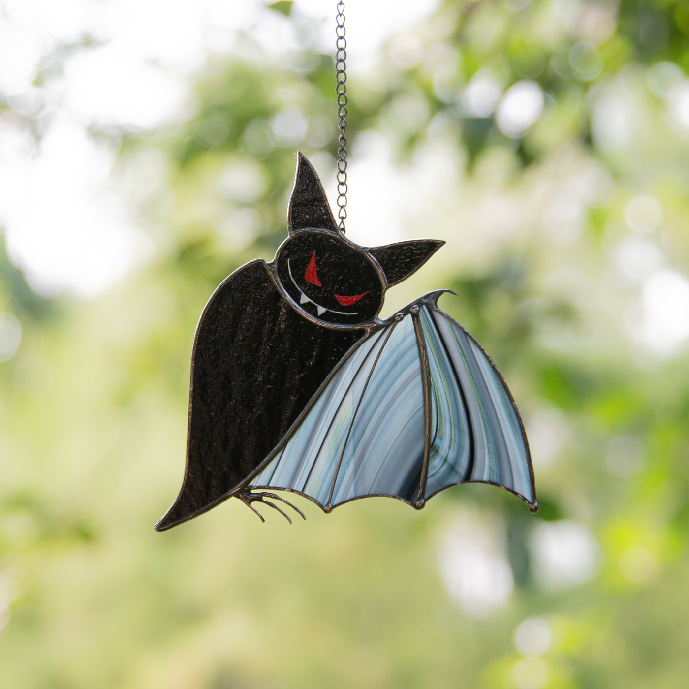 Halloween stained glass black bat with red eyes and baroque wings suncatcher