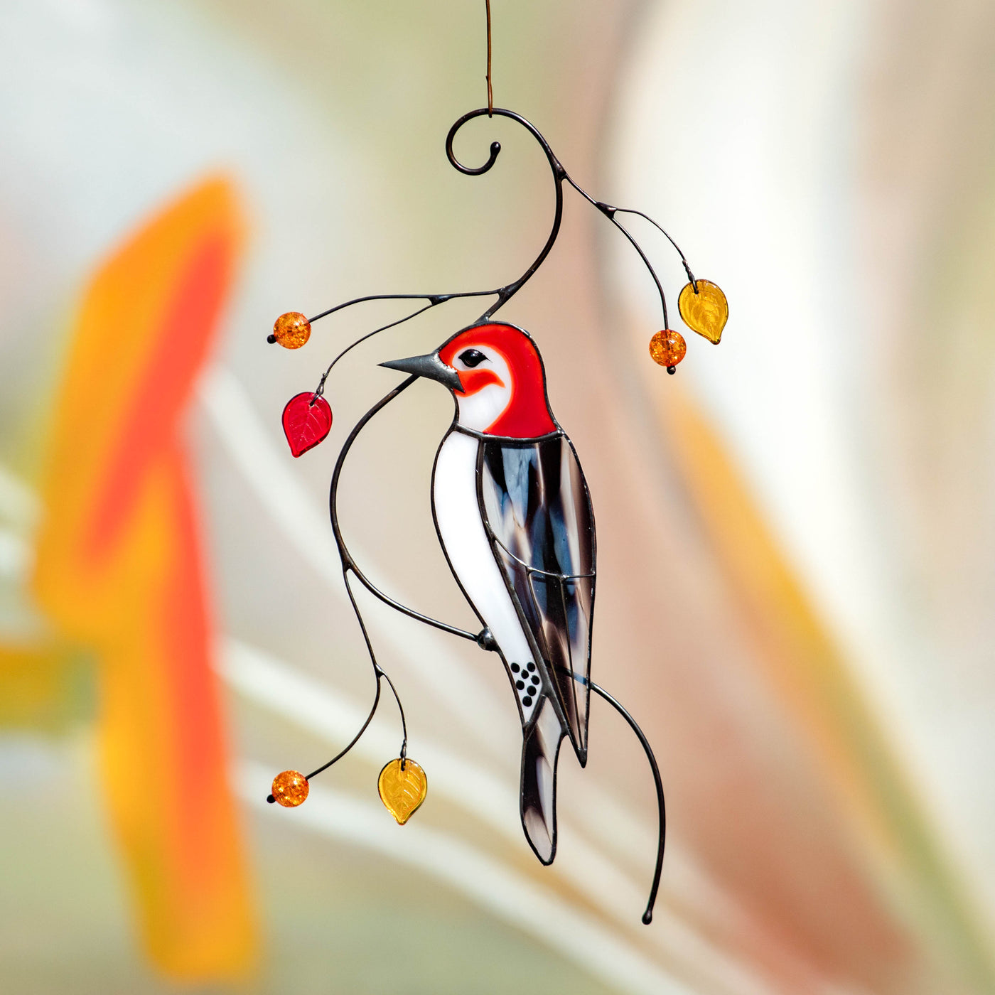 Stained glass woodpecker sitting on the branch with leaves and berries suncatcher