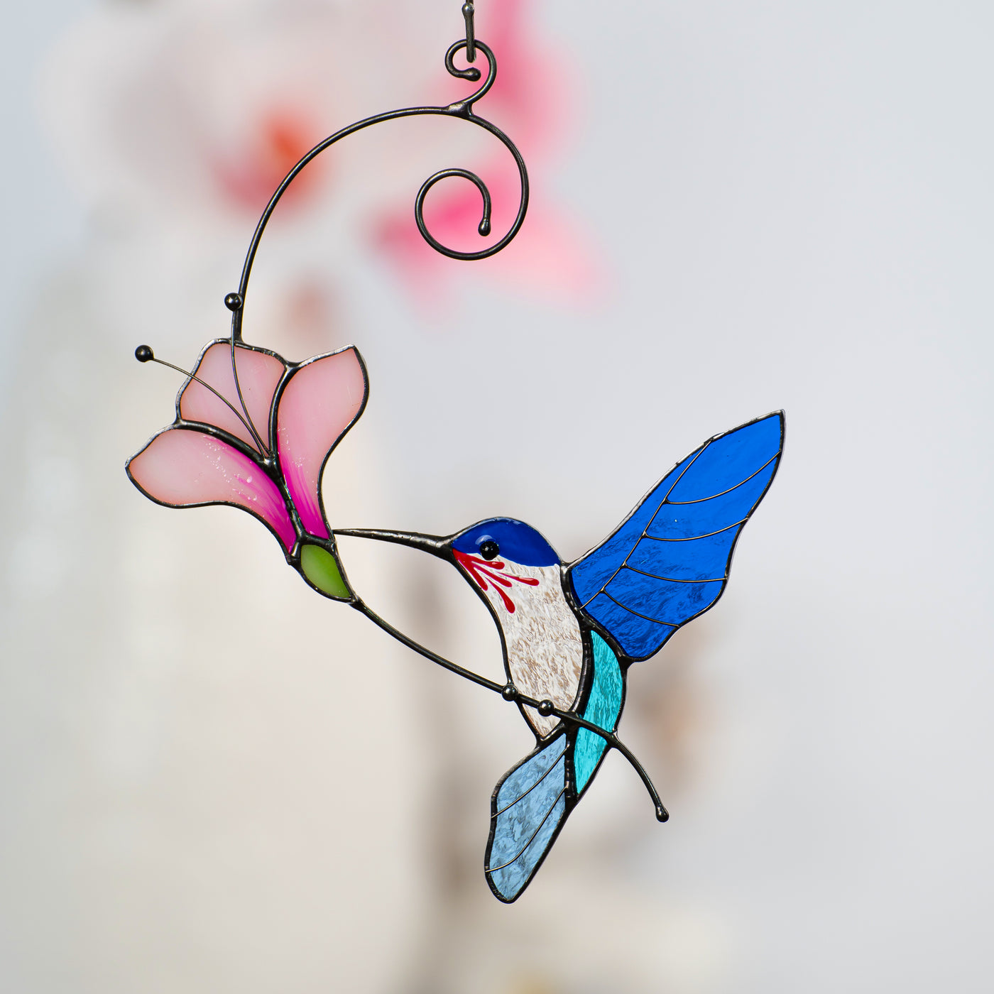 Stained glass hummingbird with the pink flower suncatcher