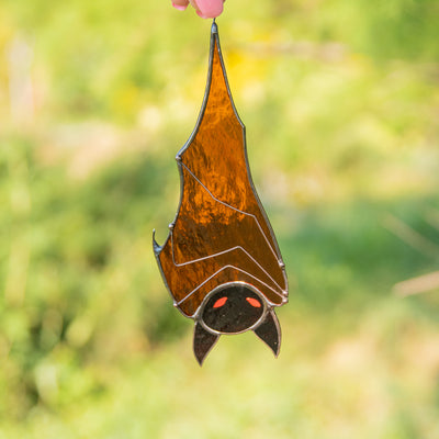 Halloween brown bat hanging down suncatcher of stained glass