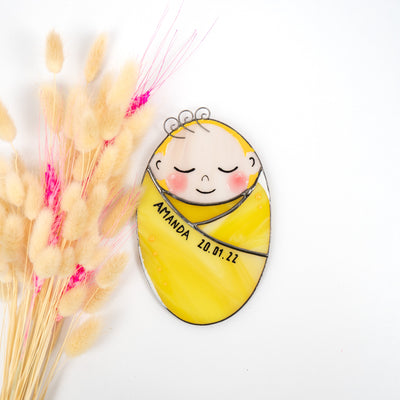 Stained glass baby girl in a yellow receiving blanket with the name and birthdate on it suncatcher