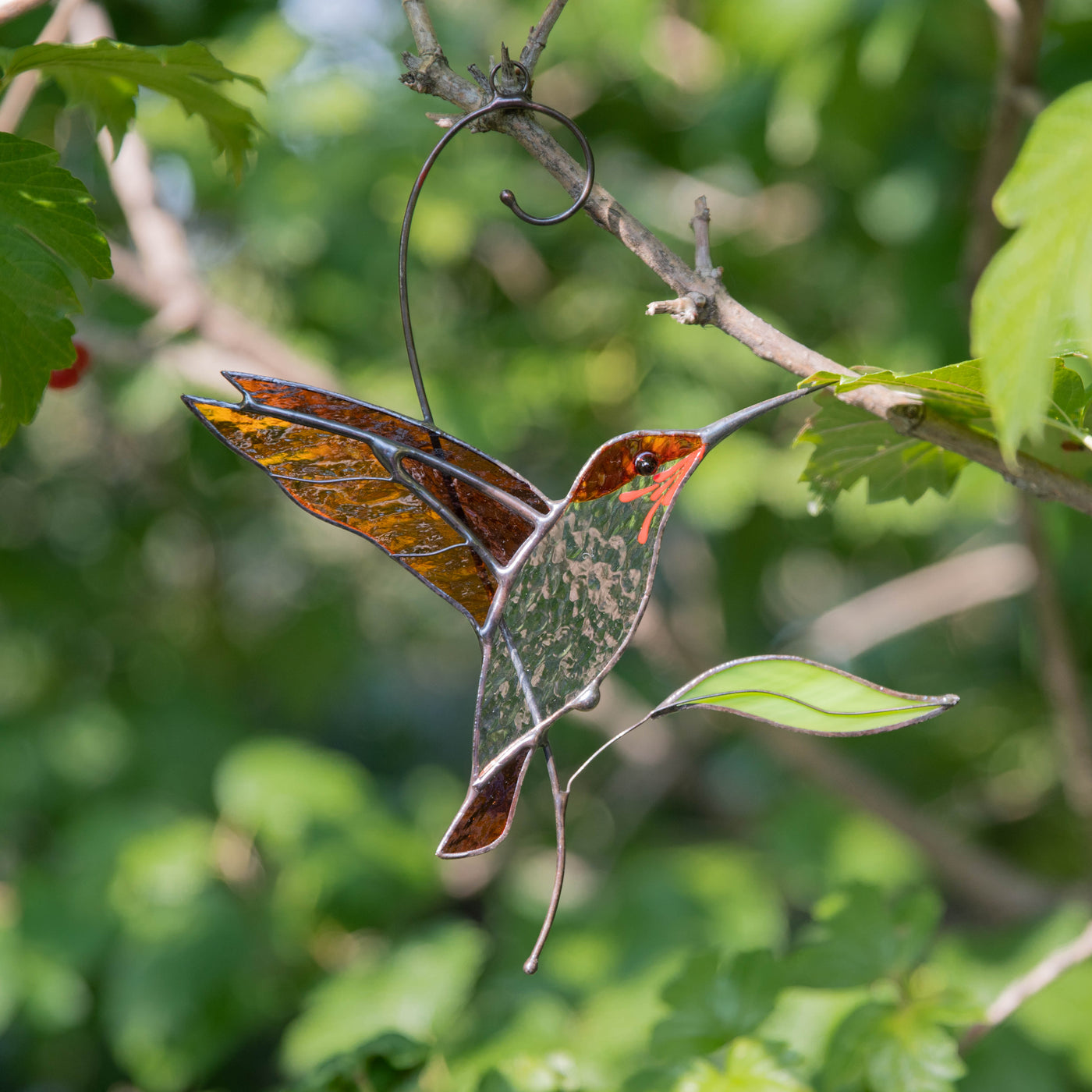 Flying golden hummingbird suncatcher of stained glass