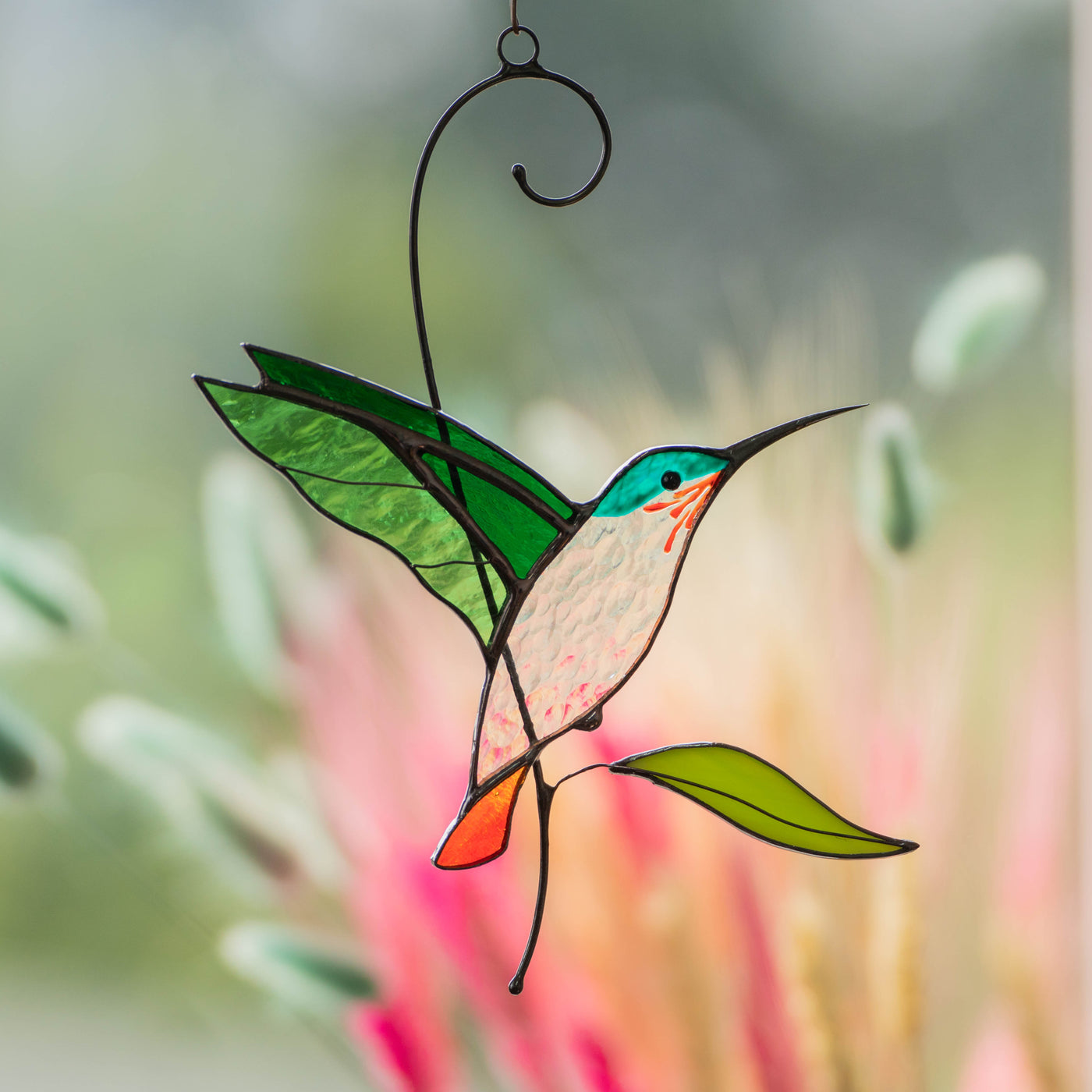 Zoomed stained glass flying green hummingbird