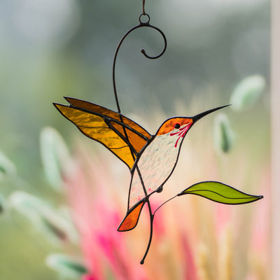 Zoomed stained glass golden flying hummingbird