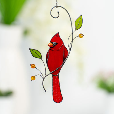 Red winter bird on the branch suncatcher of stained glass