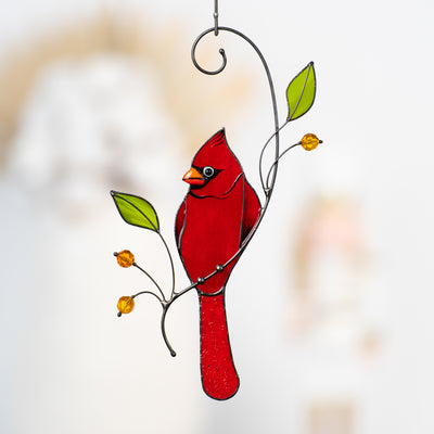 Stained glass red cardinal on the branch with leaves and berries suncatcher