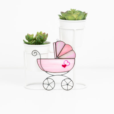 Stained glass baby stroller suncatcher of pink color