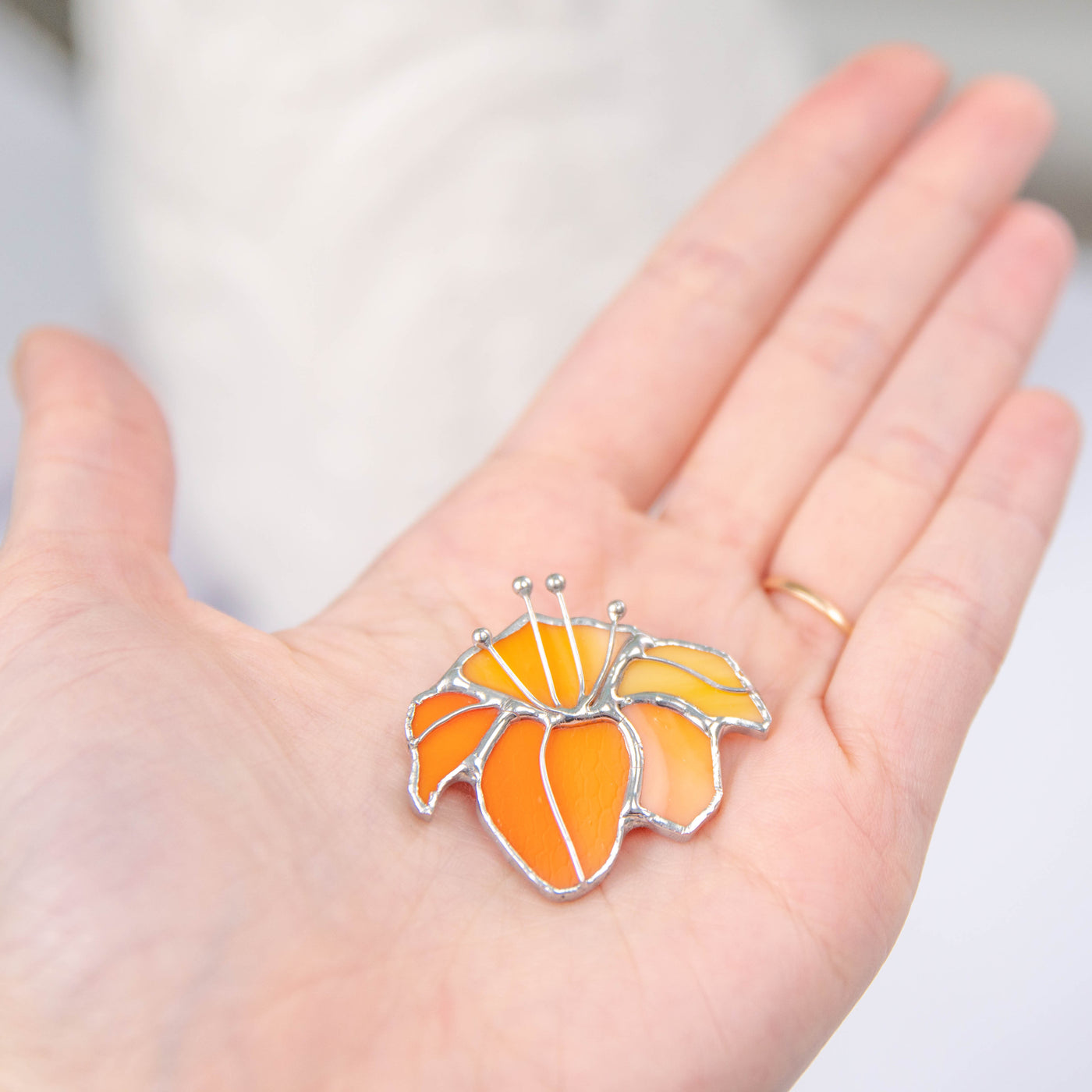 Orange lily pin of stained glass