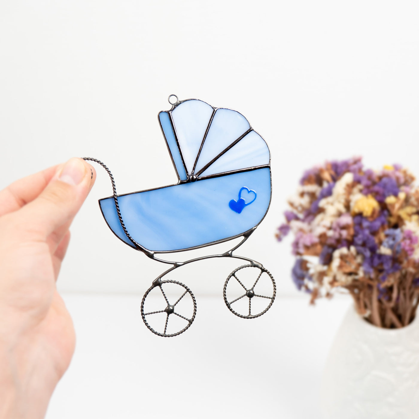 Blue baby stroller window hanging of stained glass