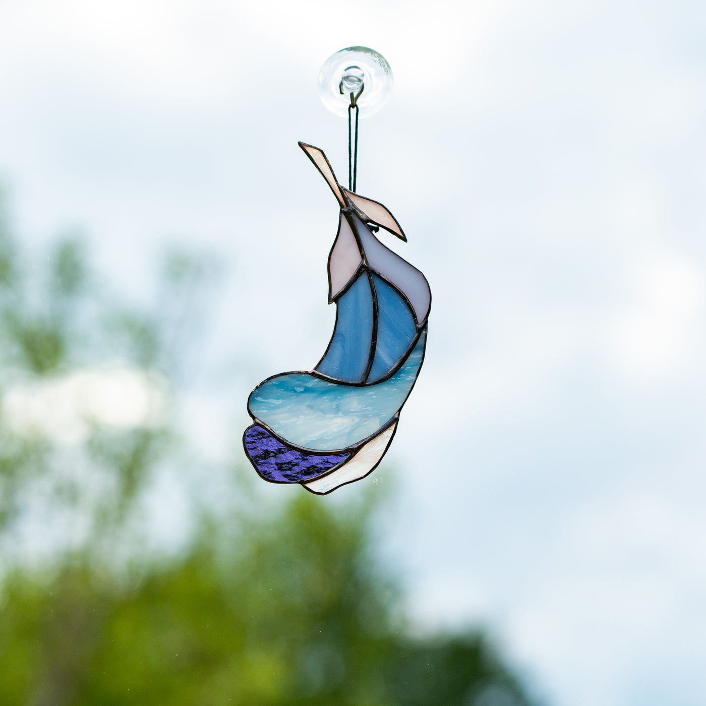 Stained glass blue feather with white and purple parts suncatcher