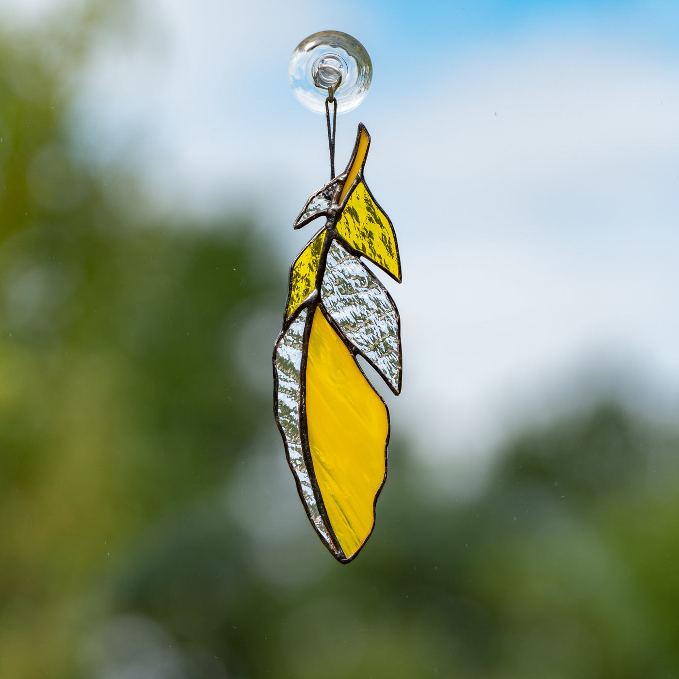 Yellow with clear parts stained glass feather suncatcher