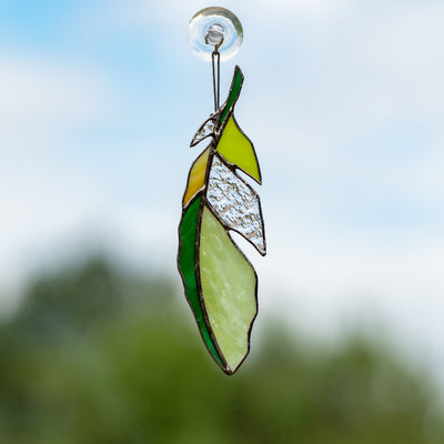 Green with clear parts stained glass feather window hanging