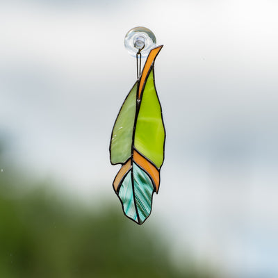 Modern stained glass feather suncatcher of green colour and its shades