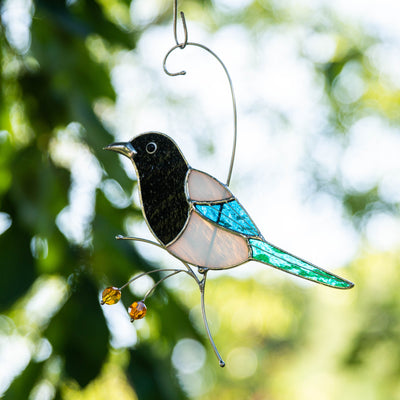 Stained glass magpie sitting on the branch and looking left suncatcher