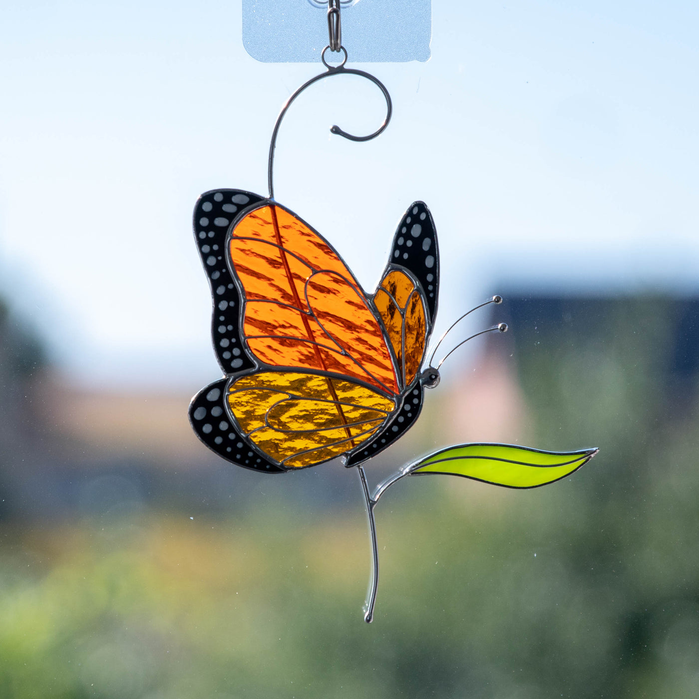 Monarch butterfly sitting on a branch stained glass suncatcher 