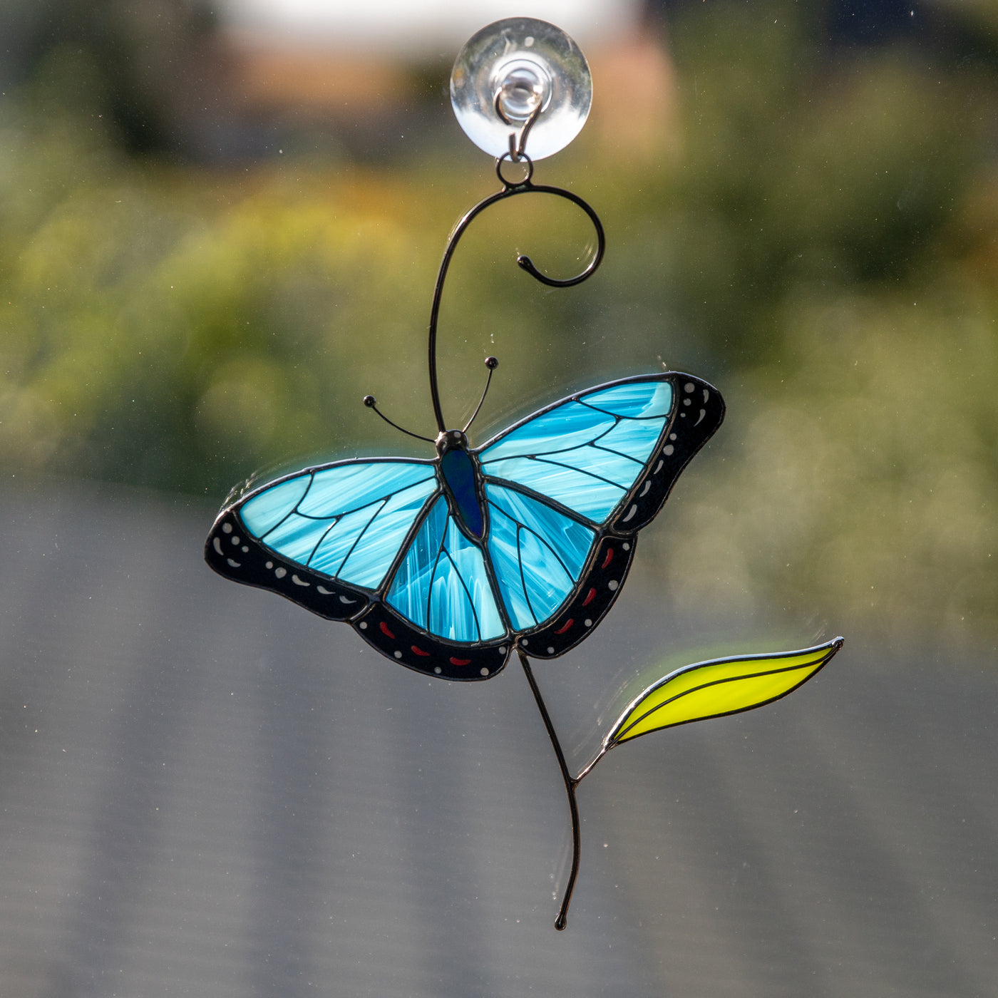 Stained glass morpho butterfly on the branch suncatcher 