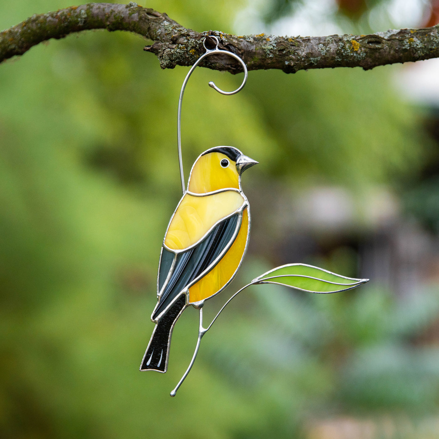 Sitting on the branch goldfinch suncatcher of stained glass