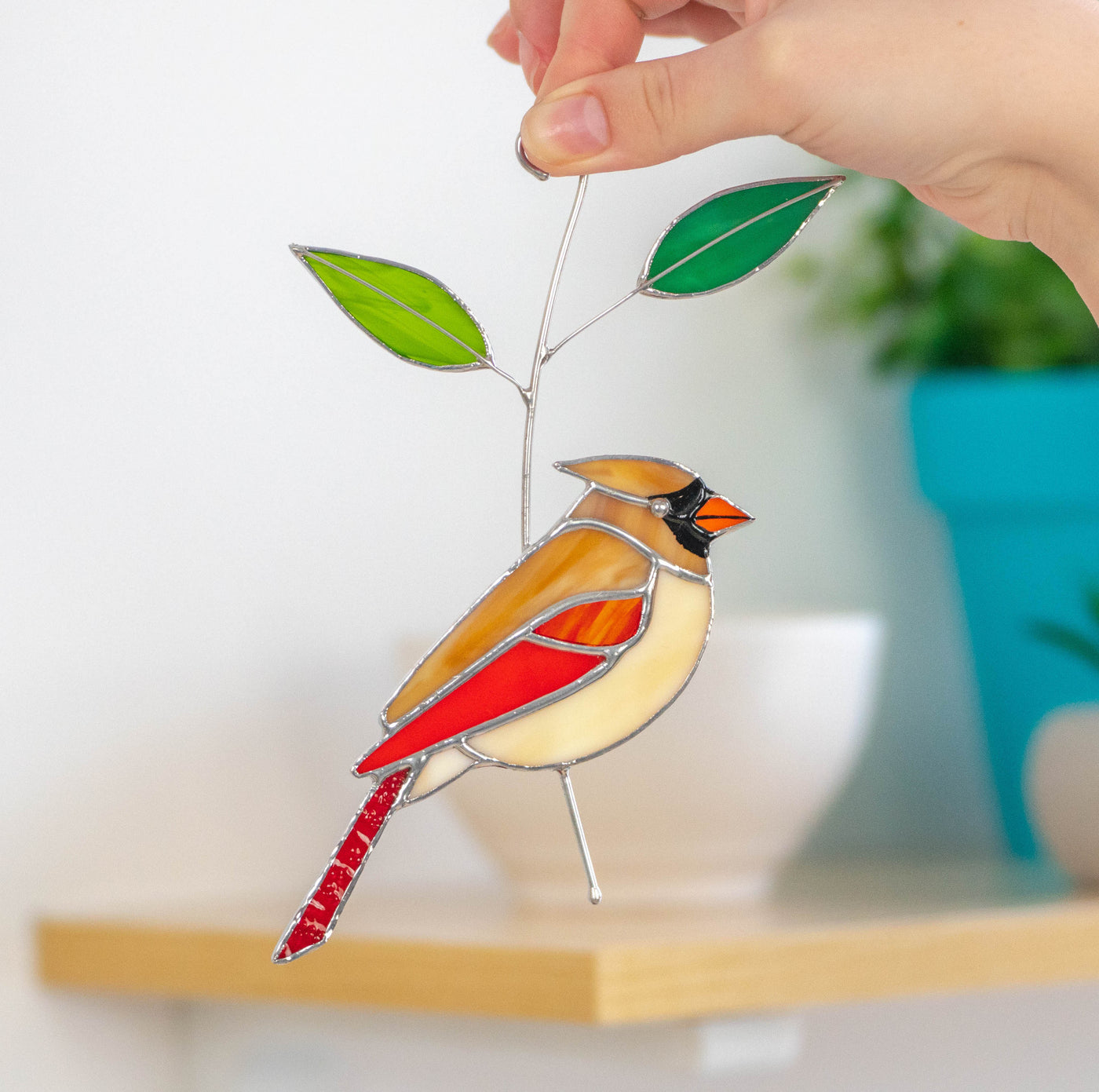 Stained glass female cardinal suncatcher sitting on the branch 