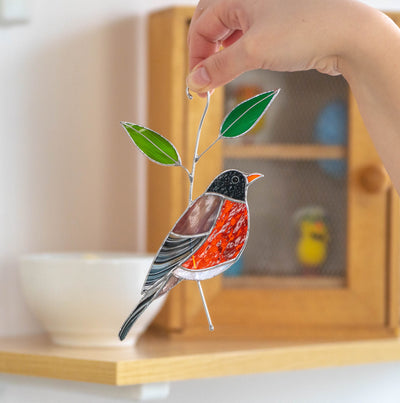Stained glass American robin bird on the branch with leaves suncatcher 