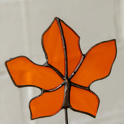 Zoomed stained glass orange maple leaf suncatcher