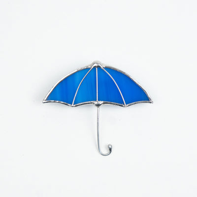 Stained glass brooch of a blue umbrella