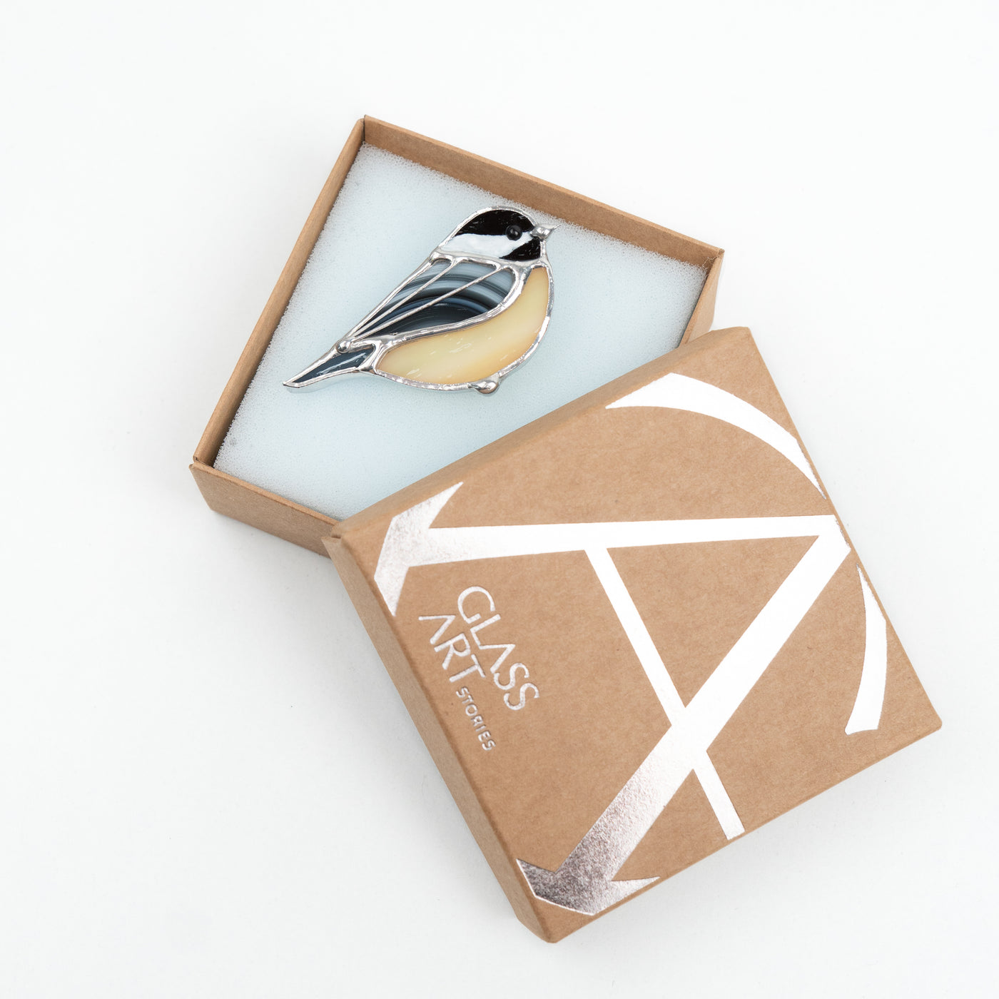 Stained glass yellow chickadee pin in a brand box