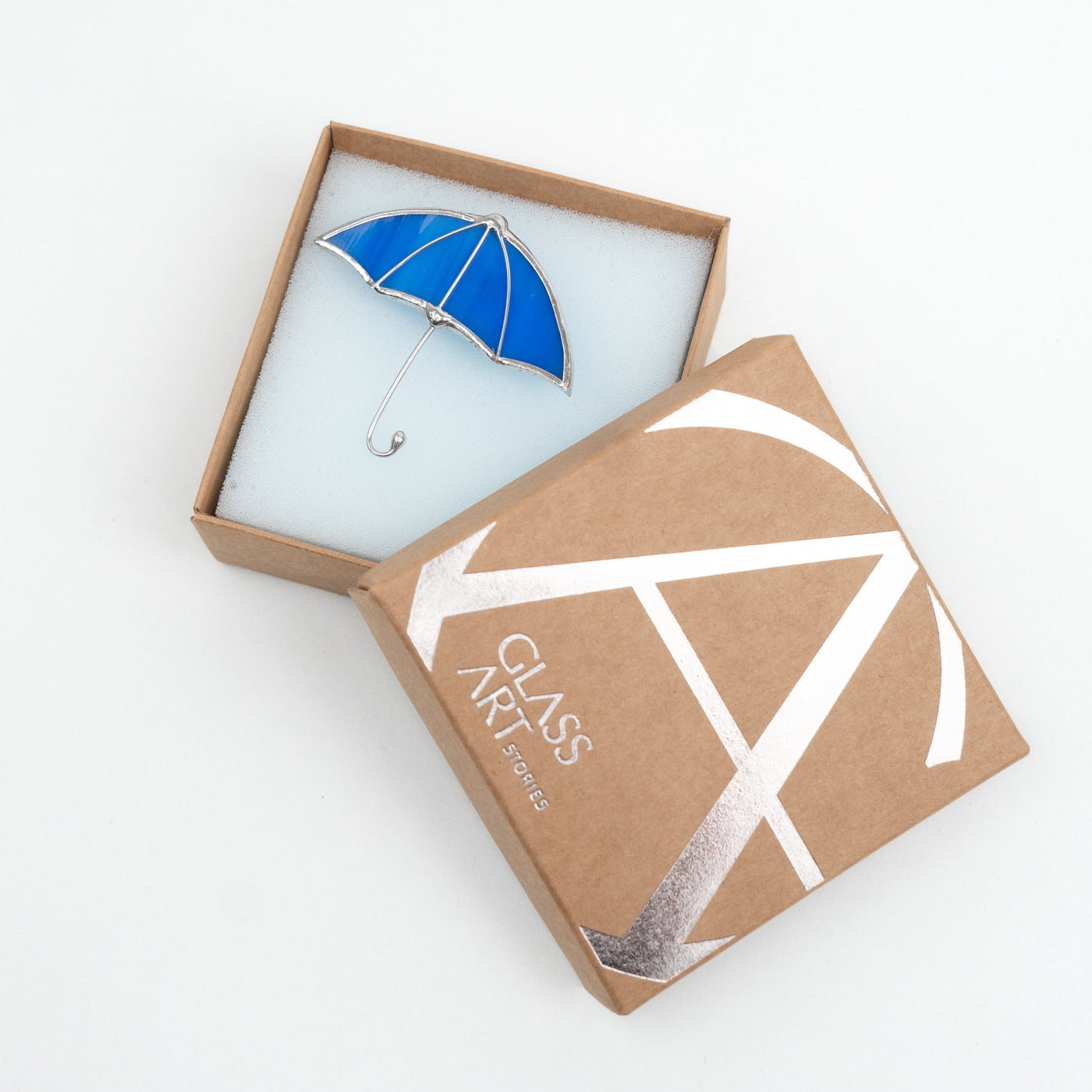 Blue umbrella brooch in a brand box