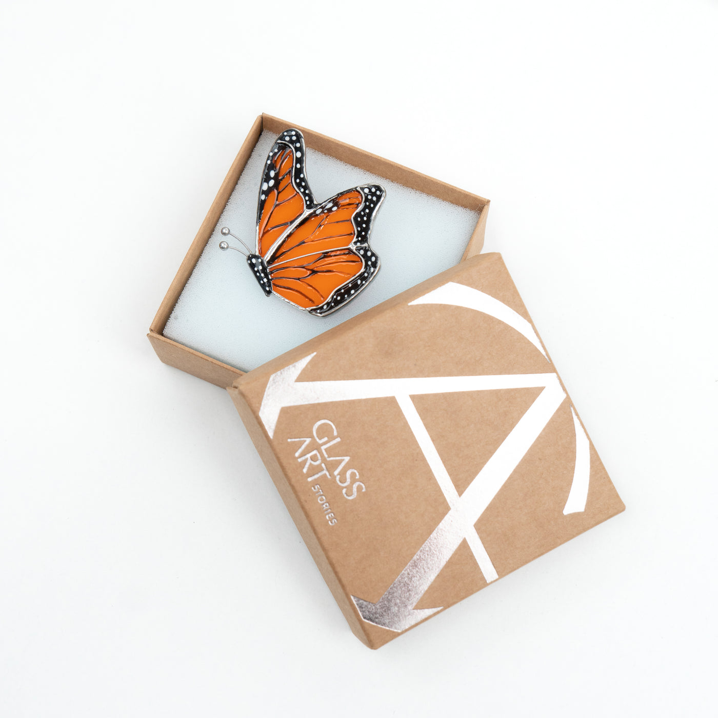 Stained glass side-view monarch butterfly pin in a brand box