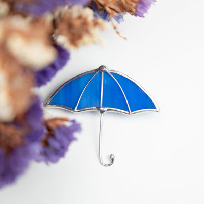 Zoomed stained glass blue umbrella pin