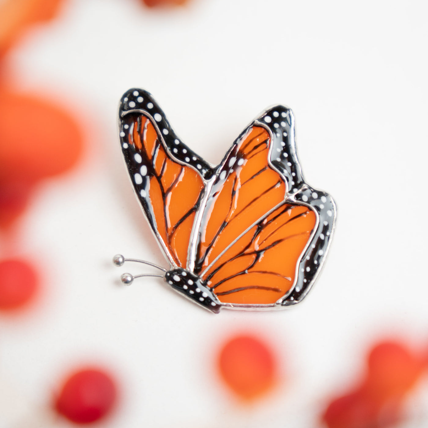Zoomed stained glass monarch butterfly side-view pin