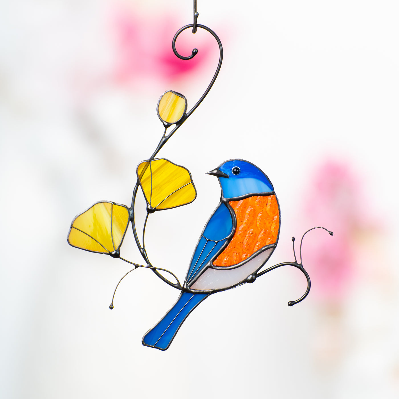 Stained glass bluebird on the branch with yellow leaves suncatcher